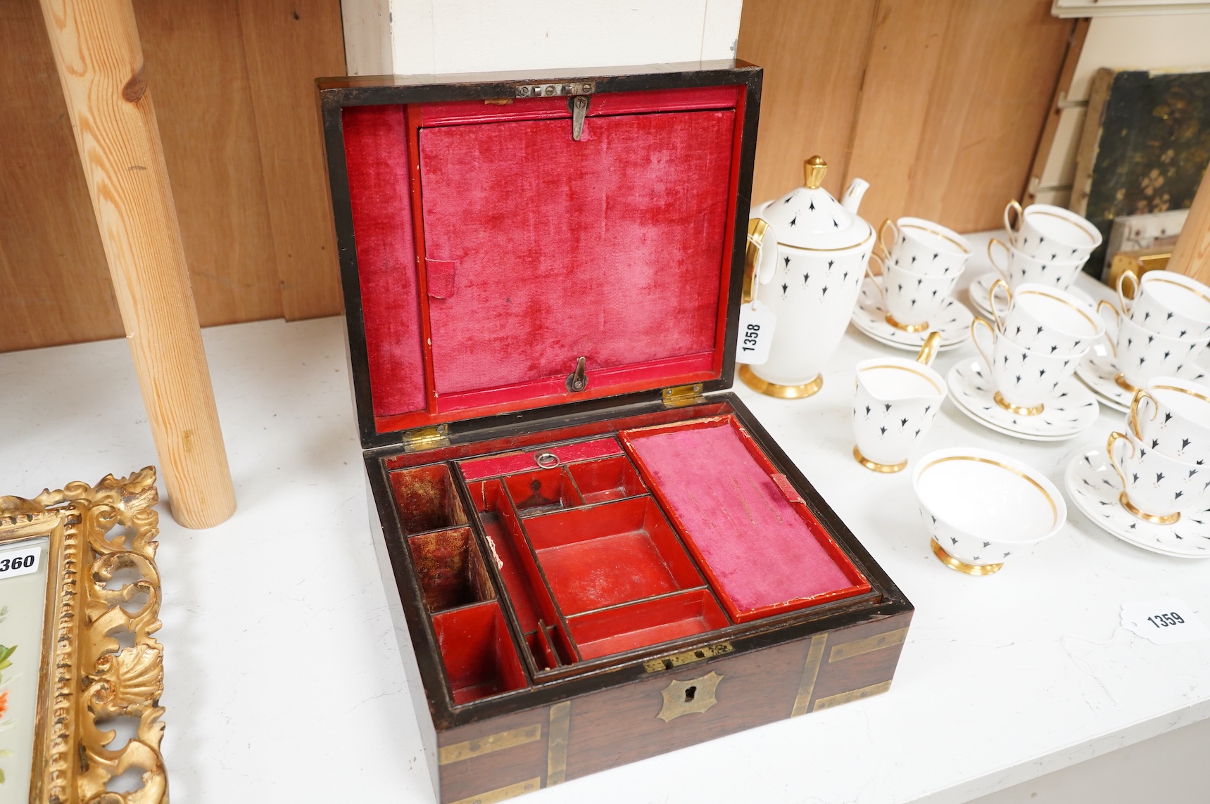 A George IV mahogany and brass bound campaign vanity box with original fittings, 27cm wide x 23cm deep x 10cm high